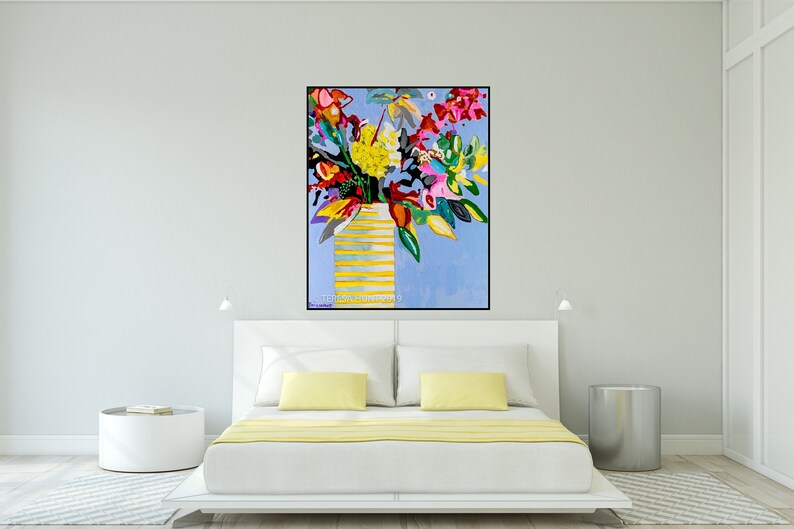 May include: A colorful abstract painting of a bouquet of flowers in a yellow striped vase on a light blue background. The painting is framed in black and has the artist's signature in the bottom right corner.