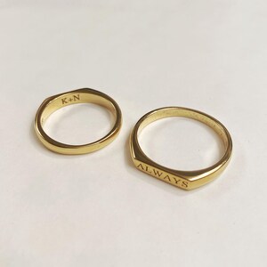 May include: Two gold rings, one engraved with "K+N" and the other with "ALWAYS".