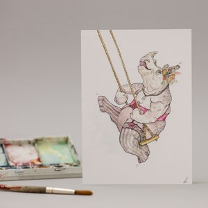 May include: A watercolor illustration of a rhinoceros wearing a pink and black lingerie set and a floral crown, swinging on a rope swing.