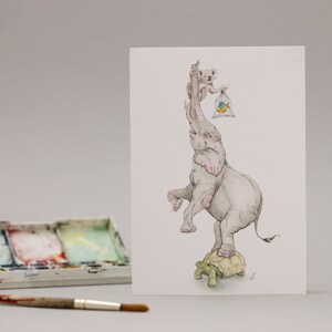 May include: A watercolour illustration of an elephant standing on a tortoise. The elephant is holding a bag with a fish inside. A koala is sitting on the elephant's back.