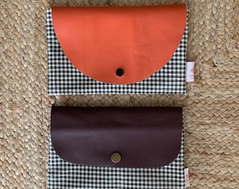 Coated canvas and leather pouch.