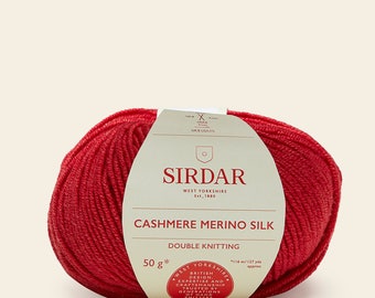 May include: A ball of red cashmere merino silk yarn for knitting. The label reads "Sirdar West Yorkshire Est. 1880 Cashmere Merino Silk Double Knitting 50g* *116 m/127 yds approx West Yorkshire British Design. Expertise and Craftsmanship Trusted by Generations of Hand Knitters"