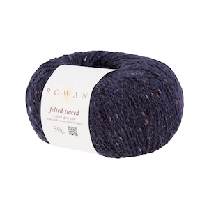 May include: A ball of navy blue felted tweed yarn with flecks of color. The label reads "ROWAN felted tweed" and "50g". The yarn is made with merino wool and alpaca. Ideal for knitting and crochet projects.
