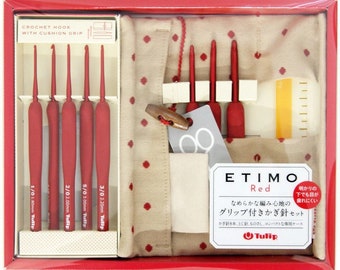 May include: A set of red crochet hooks with cushioned grips in a beige and red polka dot pouch. The set includes 8 hooks, a needle, a ruler, and a case. The packaging says "ETIMO Red" and "Tulip".