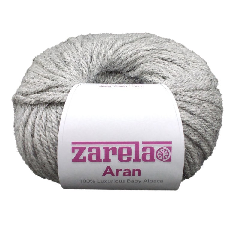 May include: A skein of light gray yarn labeled "zarela Aran 100% Luxurious Baby Alpaca".