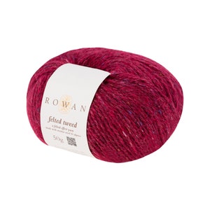 May include: A skein of Rowan Felted Tweed yarn in a deep burgundy red colour with flecks of blue and purple. The label reads "Felted Tweed, a felted effect yarn made with merino wool & alpaca, 50g".