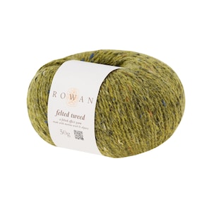 May include: A ball of Rowan Felted Tweed yarn in a muted green shade, speckled with blue, orange, and yellow fibres. The yarn is labelled with "ROWAN felted tweed" and "50g". Made with merino wool and alpaca. Ideal for knitting and crochet projects.