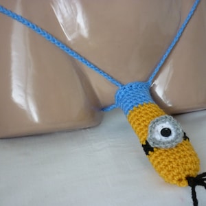 May include: A blue and yellow crocheted Minion-themed thong with a single black eye and a black hairpiece.