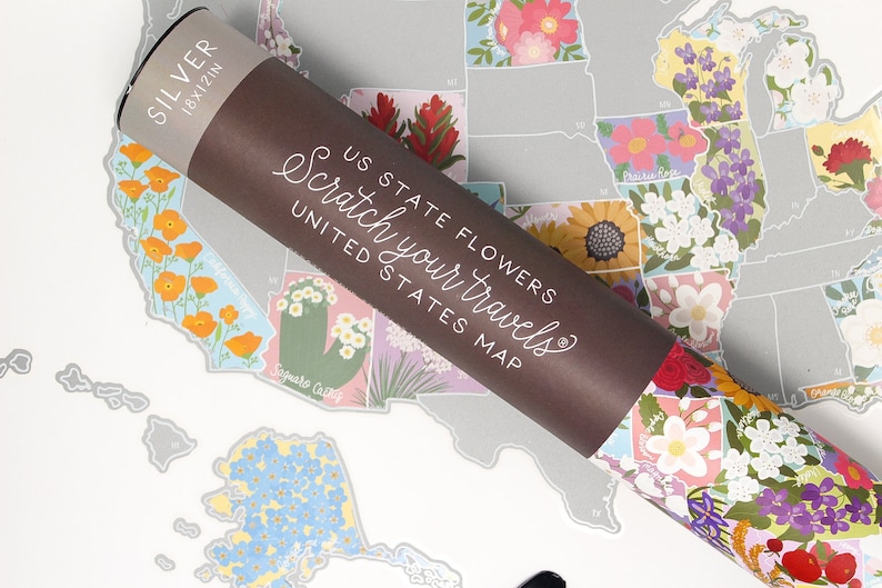 May include: A rolled up scratch-off map of the United States with each state illustrated with its state flower. The map is labeled "US State Flowers Scratch Your Travels United States Map".