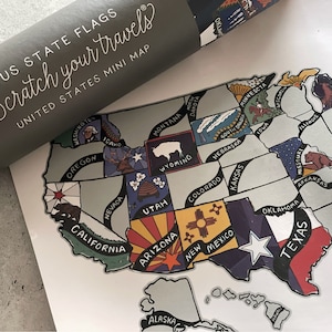 May include: A scratch-off map of the United States with each state's flag illustrated in colorful detail. The map is titled "Scratch Your Travels" and "United States Mini Map".