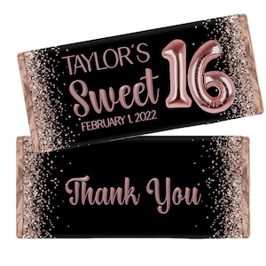 May include: Two chocolate bar wrappers with a black background and rose gold accents. The top wrapper reads "Taylor's Sweet 16 February 1, 2022" with a rose gold "16" balloon. The bottom wrapper says "Thank You" in rose gold.