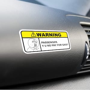 May include: A yellow and white warning sticker with a cartoon face and the text "WARNING. PASSENGER. YU NO PAY FOR GAS?"