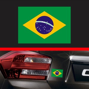 May include: A black car with a green, yellow, and blue Brazilian flag sticker on the back.
