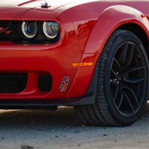 May include: A red Dodge Challenger with a black "I've heard of the Mafia, you're the best I've heard" sticker on the front fender.