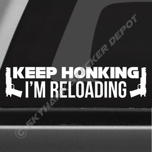 May include: White vinyl sticker with the text "KEEP HONKING I'M RELOADING" and two gun silhouettes on either side.