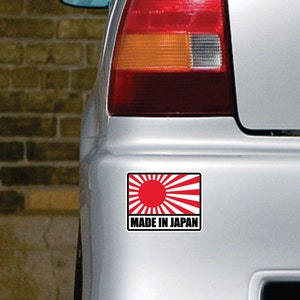 May include: A red and white sticker with a rising sun design and the text "Made in Japan".
