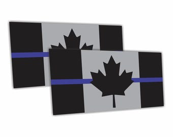 May include: Two rectangular stickers featuring a Canadian flag design. The flags have a black and gray color scheme with a black maple leaf in the center. A blue stripe runs horizontally across the center of the flag.