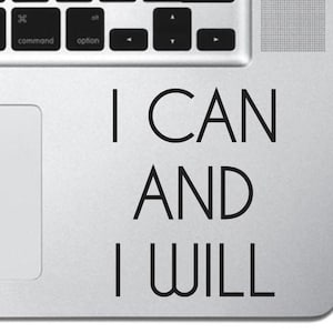 May include: A silver laptop with a black vinyl sticker that reads "I CAN AND I WILL".