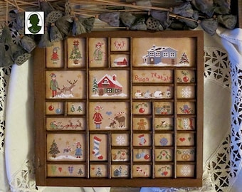 May include: A vintage wooden frame with 25 individual compartments, each containing a different embroidered Christmas scene. The frame is decorated with a brown background and features a variety of festive imagery, including a Christmas tree, a gingerbread man, a stocking, and a house. The text "Buon Natale" is visible in the center of the frame.