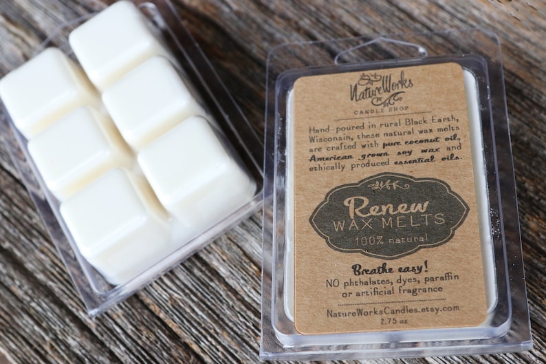 May include: A clear plastic container of wax melts with six individual cubes. The container has a brown paper label with the text "NatureWorks Candle Shop", "Renew Wax Melts", "100% natural", "Breathe easy! NO phthalates, dyes, paraffin or artificial fragrance", "NatureWorksCandles.etsy.com", and "2.75 oz".