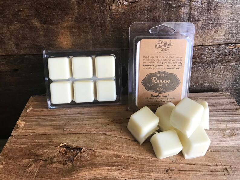 May include: Six white wax melts in a clear plastic container. The container is labeled "Renew Wax Melts" with the text "Breathe easy! NO phthalates, dyes, paraffin or artificial fragrance."