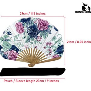 May include: A white folding fan with a floral design in shades of pink, blue, and green. The fan is 29 inches long and 8.25 inches wide. It comes with a black pouch that is 9 inches long.