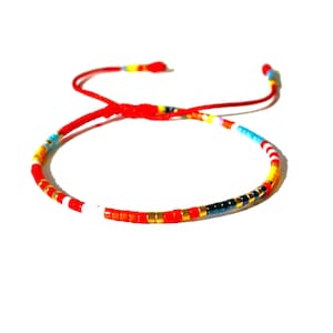 miyuki seed bead Delica bracelet in red, yellow, black, gold, white, light blue, color beads, on adjustable red string waterproof bracelet handmade to order in USA by Lucky Charms USA