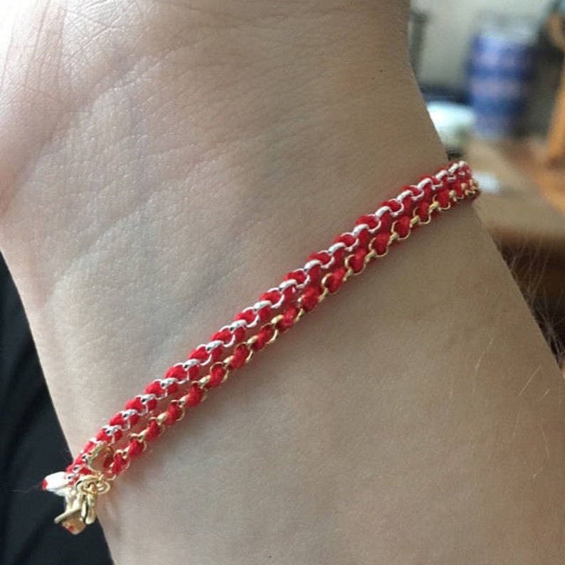 Model wife showing on wrist handmade and handwoven gold-filled and sterling silver kabbalah redline string bracelets for extra protection from negative energies and bad luck Hand-crafted by Lucky Charms USA