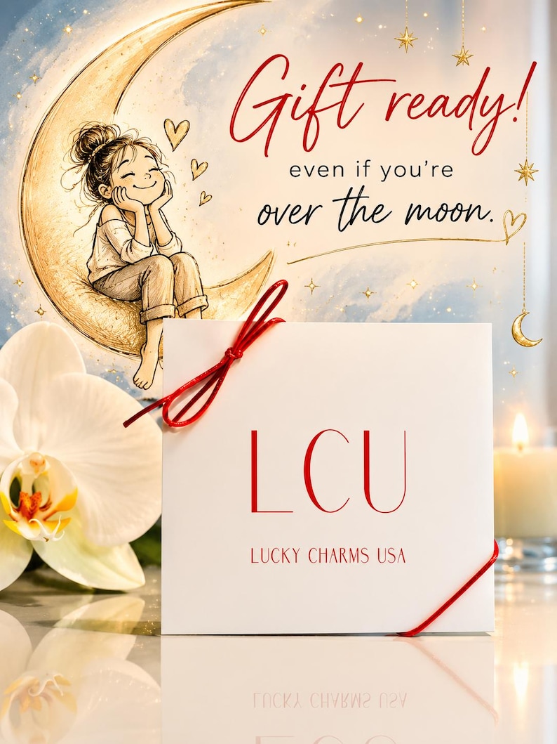 Gift ready jewelry packaging photo featuring Lucky Charms USA necklace card styled with a dreamy illustrated moon background, delicate hand-drawn details, soft candlelight, orchid accents, and the phrase “Gift ready! even if you’re over the moon.”