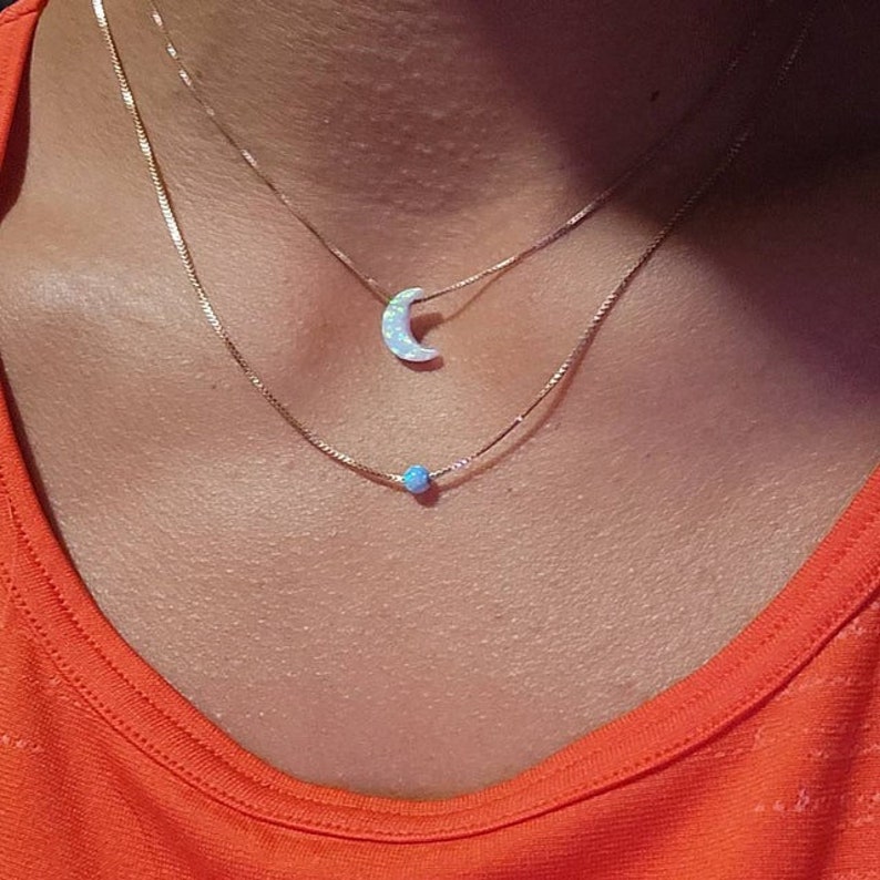 Girl wearing white opal moon necklace on sterling silver box chain and blue opal ball on sterling silver box chain opal-gifts by Lucky Charms USA