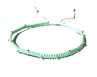 The 'Vita' macramé bracelets in delicate protective turquoise string and gold-filled balls