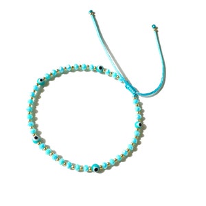 Mal de ojo con cristales azules y cuentas llenas de oro en una cuerda de color azul turquesa ajustable, joyería de regalo hecha a mano a prueba de agua para mujeres por Lucky Charms USA