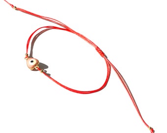 Love guard pink heart evil eye bracelet in gold-filled and pretty salmon color string to safe guard love and friendship