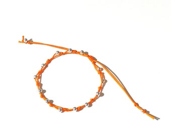 Silver ball bracelet on orange color string your daily vitamin C by Lucky Charms USA