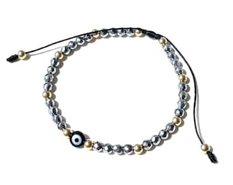 Shiny hematite beads with a special evil eye design and accented with gold-filled balls a stylish protection jewelry and attract good-luck