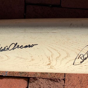 May include: A white wooden baseball bat signed by "Eddie Cicotte" and "Babe Ruth".