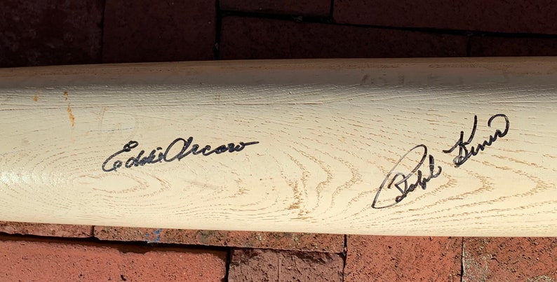 May include: A white wooden baseball bat signed by "Eddie Cicotte" and "Babe Ruth".