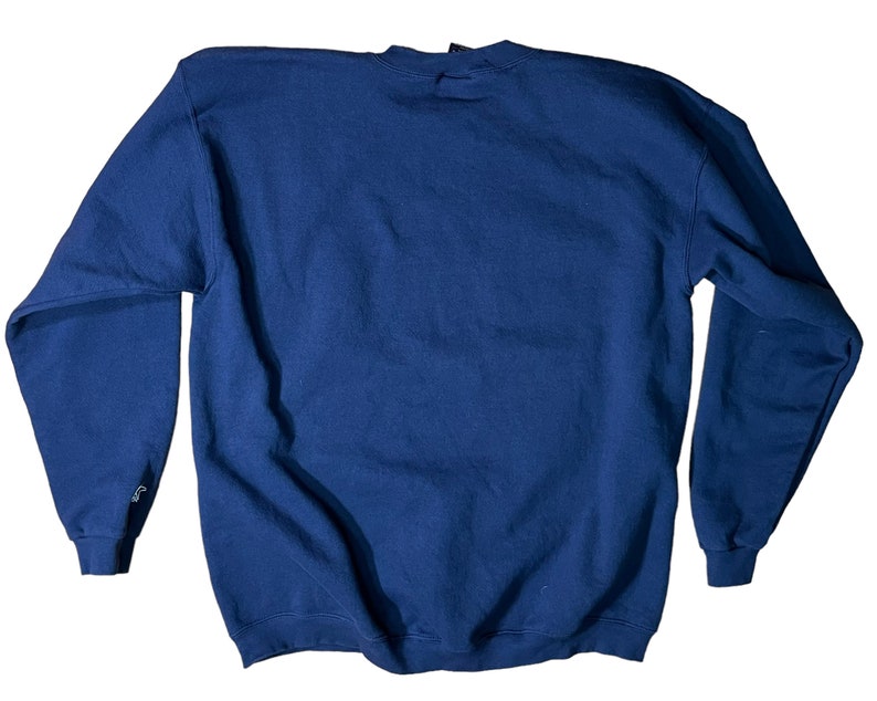 May include: A navy blue sweatshirt with a crew neck and long sleeves.