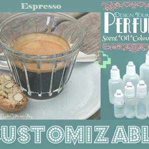 May include: A glass of espresso with a biscotti cookie on a white saucer. The image also shows a set of six clear glass bottles with white caps, labeled with different sizes in milliliters. The text "DESIGN YOUR OWN PERFUME" is displayed above the bottles. The text "Scent*Oil*Colour*Size" is displayed below the bottles. The text "CUSTOMIZABLE" is displayed at the bottom of the image.