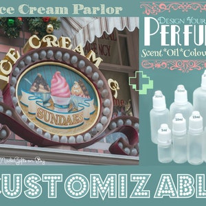 May include: A sign for an ice cream parlor with the words "Ice Cream Parlor", "ICE CREAM", and "SUNDAES" on it. The sign is decorated with lights and has a picture of three ice cream sundaes on it. The sign is hanging from a brick building. There is a sign on the right side of the image that says "DESIGN YOUR OWN PERFUME Scent*Oil*Colour*Size" and shows a variety of perfume bottles in different sizes.