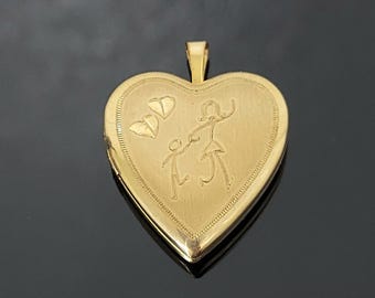 May include: A gold heart-shaped locket pendant. The locket features an engraved design of a parent and child, with two hearts above. The pendant has a textured border and a small loop for a chain.