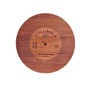May include: A vintage-style record with a woodgrain design. The label features the text "Columbia", "Willie Nelson", "On the Road Again", and "1-11351".