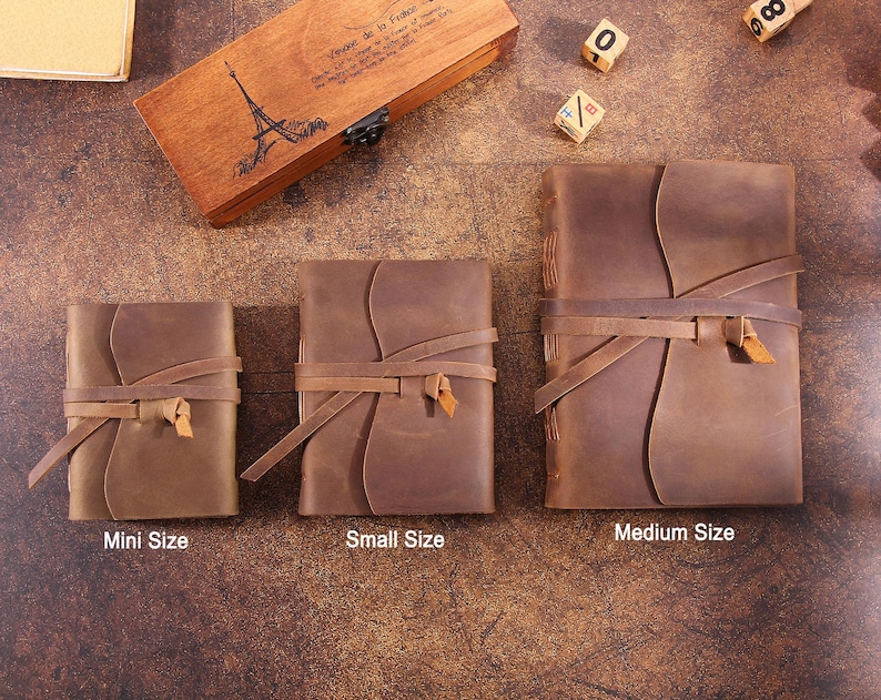 May include: Three brown leather journals of different sizes, labeled "Mini Size", "Small Size", and "Medium Size". Each journal has a leather strap closure and is made of distressed leather.