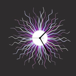 May include: A decorative wall clock with a sunburst design. The clock features a white face with black hands and a colorful array of wavy lines in shades of purple, lavender, and white radiating from the center. The background is dark gray.