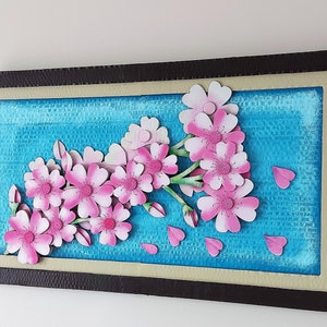 Flores de cerezo sobre un marco de composición 3D. Una obra de arte única y hermosa hecha de cartón reciclado.
