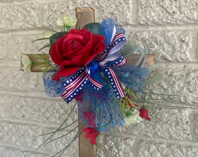 Grave memorial with patriotic flowers and ribbon