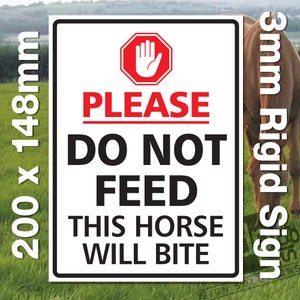 May include: A rectangular sign with a black border, displaying the text "PLEASE DO NOT FEED THIS HORSE WILL BITE" in bold black and red letters. The sign also features a red octagon with a white hand symbol. The sign measures 200 x 148mm.
