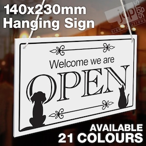 May include: White hanging sign with black text that reads "Welcome we are OPEN". The sign has a black silhouette of a dog and a cat on either side of the text. The sign is 140mm x 230mm.