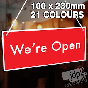 May include: Red rectangular sign with white text that reads "We're Open". The sign is hanging from a string and is 100 x 230 mm. The sign is available in 21 colors.