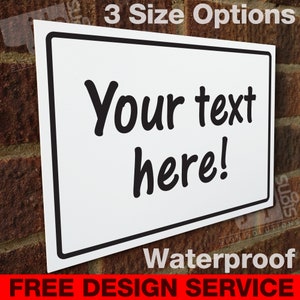 May include: White rectangular sign with a black border. The sign says "Your text here!" in black cursive font. The sign is waterproof and has a free design service.